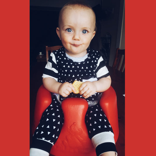 Check out Angus rocking his bright red Bumbo