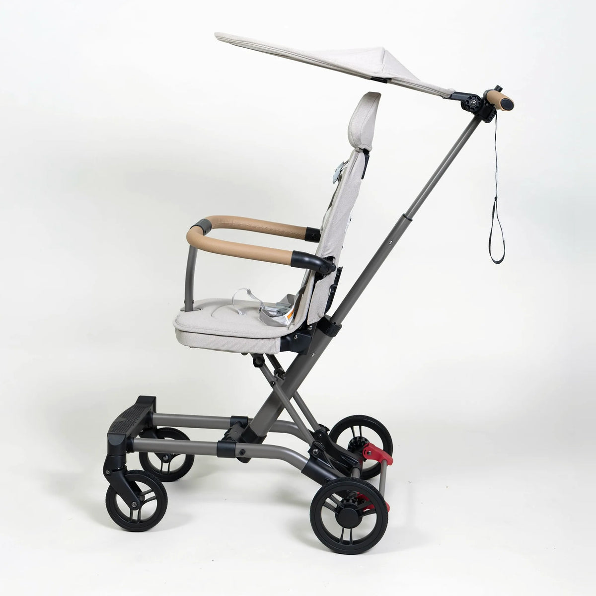 Cream Milo Co-Rider Stroller shown with canopy (sold separately) for full shade