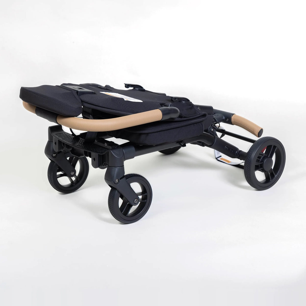 Milo Co-Rider Stroller in black, folded flat