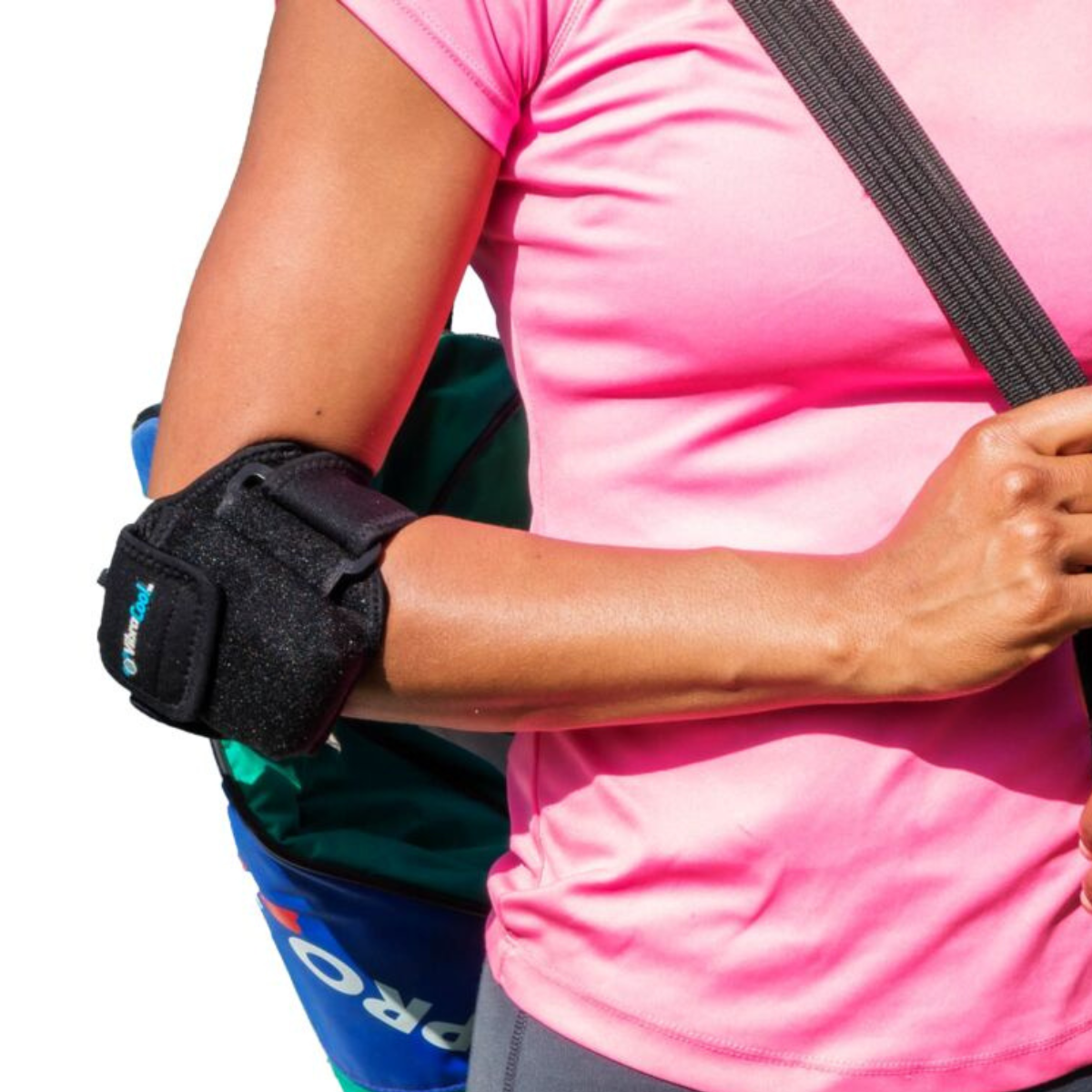 A close-up of a person wearing a VibraCool Easyfit ,elbow support brace on their right arm, paired with a pink athletic shirt and a blue bag.