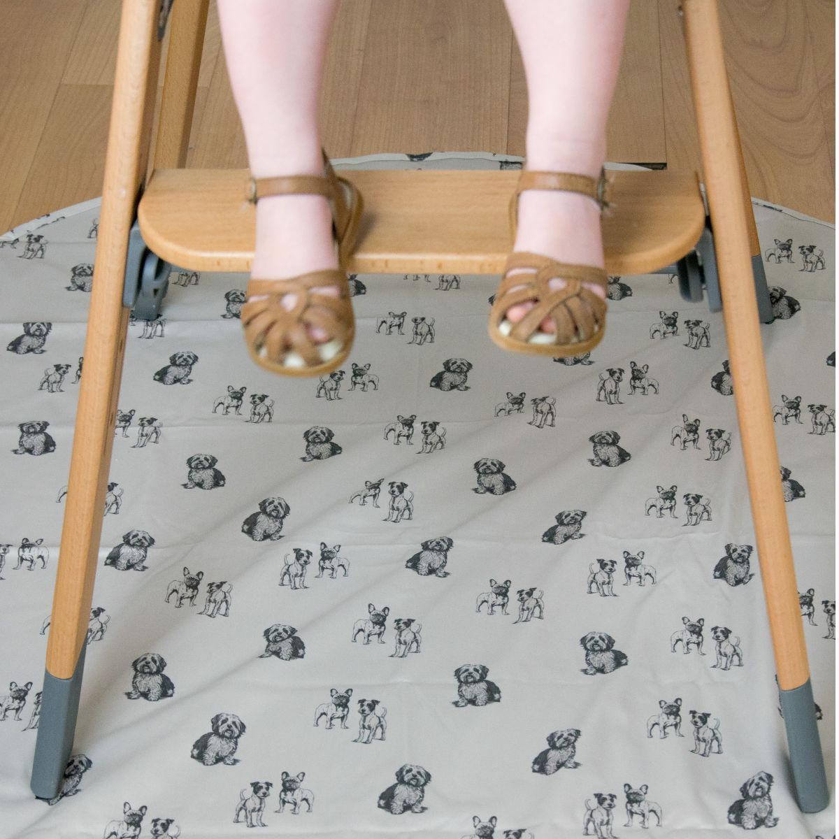 Child’s feet above the Moose Harper highchair footrest and animal print floor mat