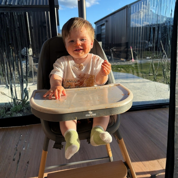 Child in a Harper high chair outdoors 