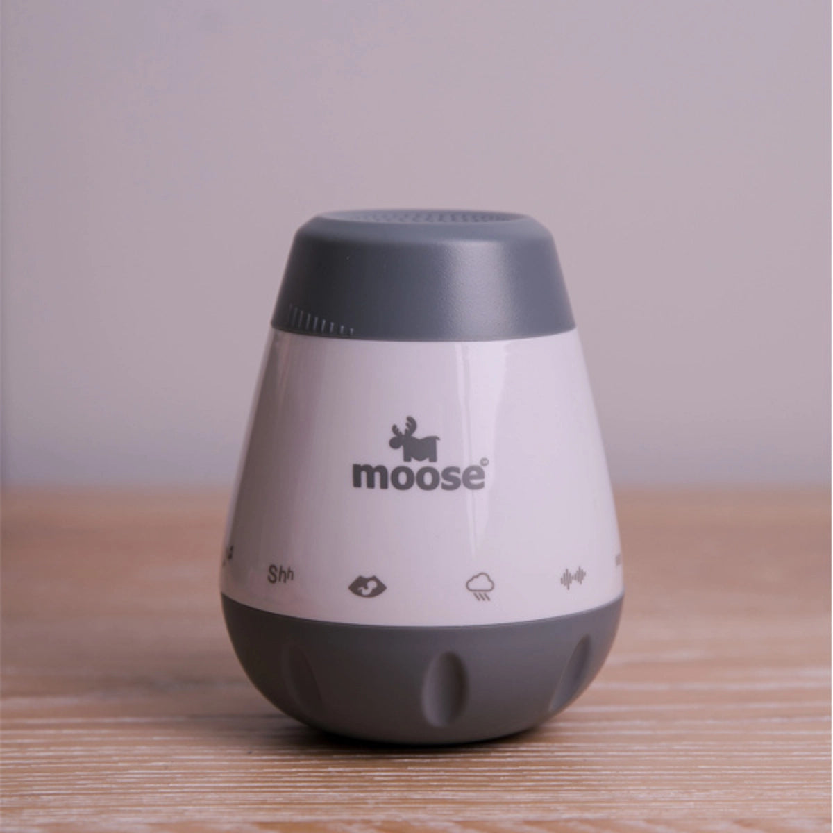 Close-up of the grey and white Moose Calm-a White Noise Machine showing its sound icons
