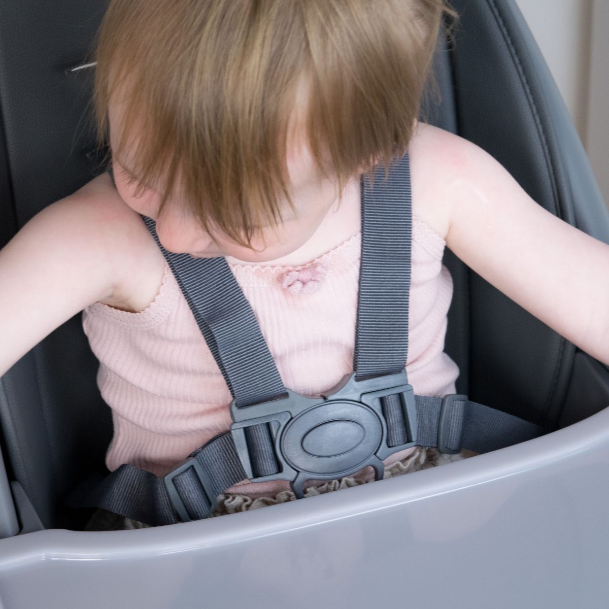 Close-up of a toddler wearing the Moose Harper highchair’s five-point harness
